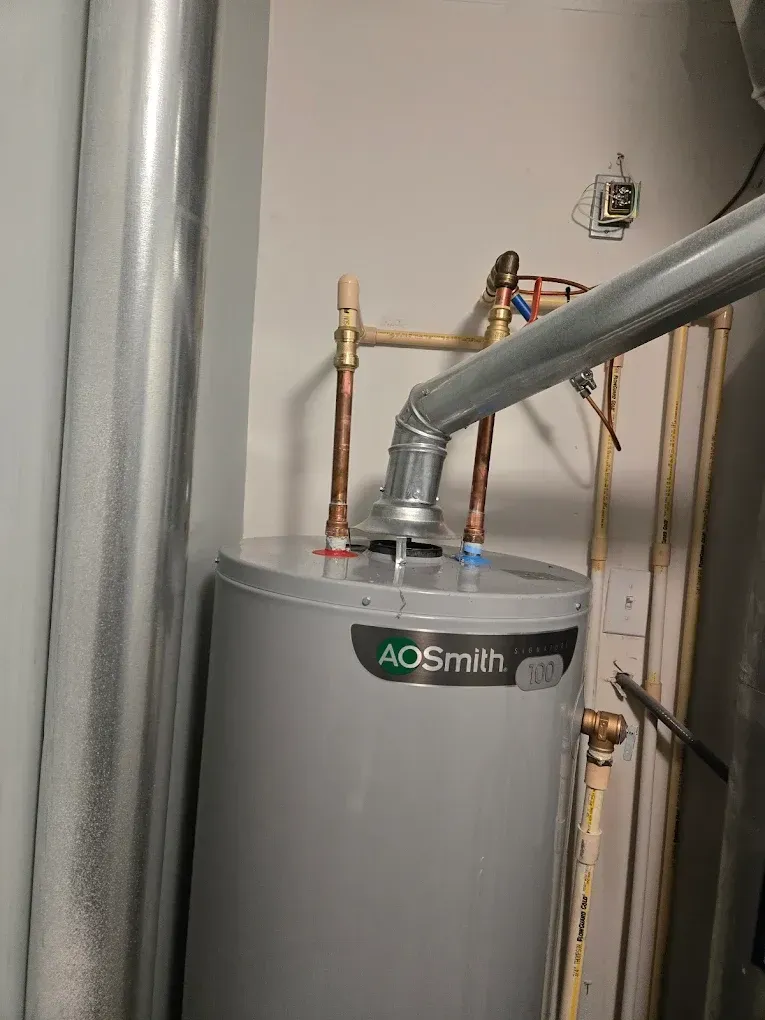 A.O. Smith water heater with metal vent pipes in a utility room