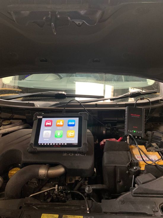 car mechanic diagnosing and checking up on car engines parts for fixing and repair
