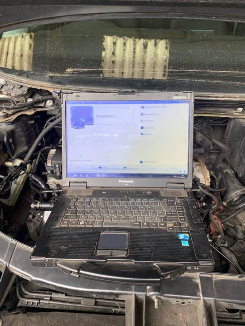 mechanic repairman hands repairing a car engine automotive workshop