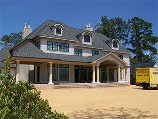 a gutter filled with leaves is on the roof of a house
