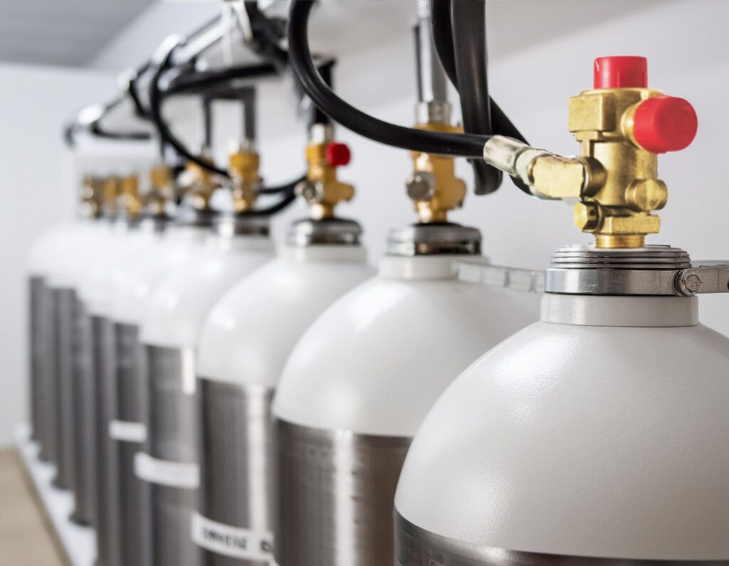 A row of gas cylinders with valves attached to them