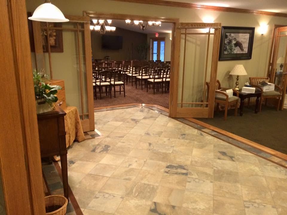 Lobby entrance to a banquet hall with open double doors and tables set in the room beyond