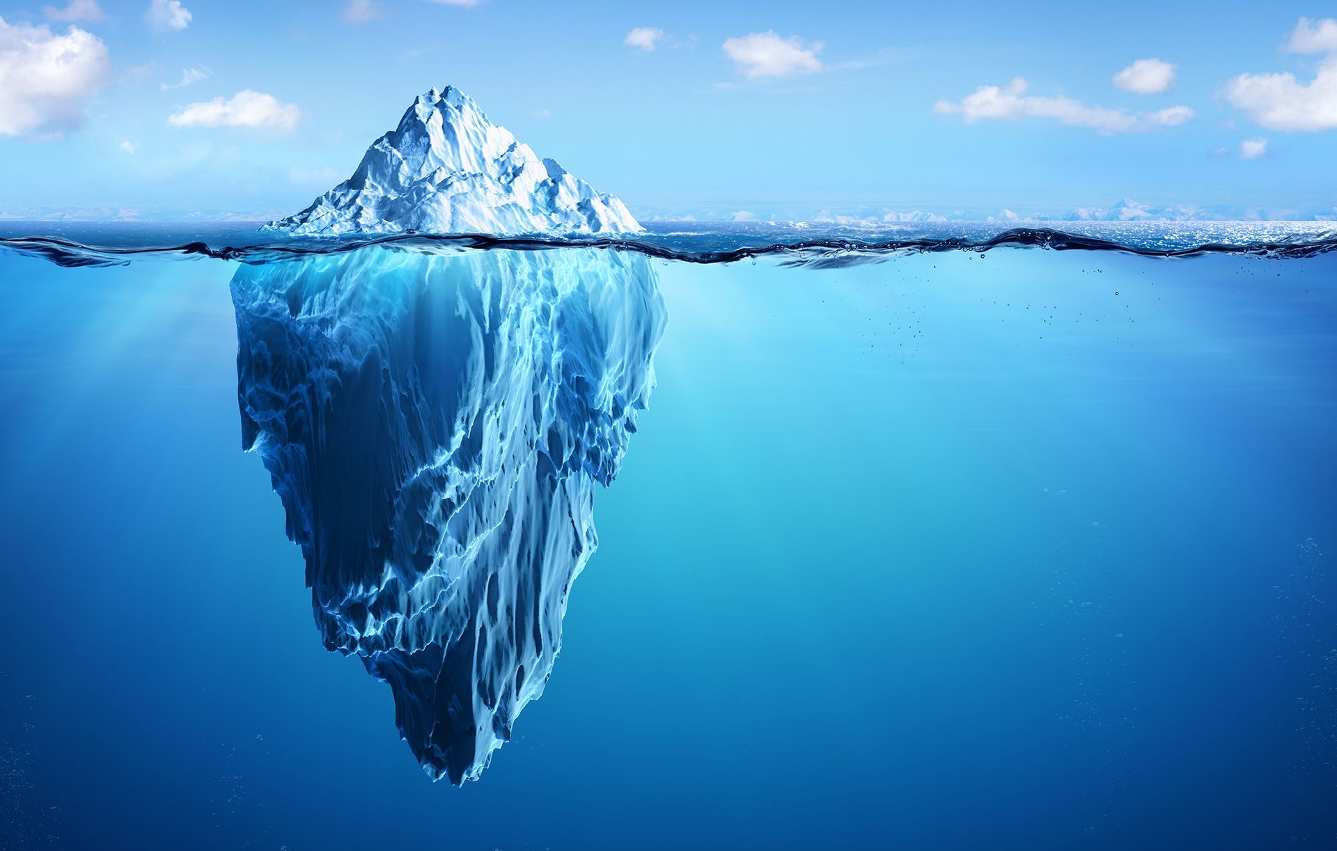 A large iceberg is floating on top of a body of water.