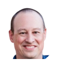 Smiling bald man in a white shirt on a plain background