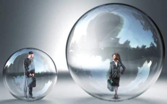 A man and a woman are standing inside of a glass sphere