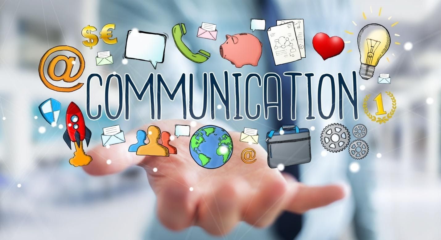 A businessman's hand holding the word 'communication' with clip art surrounding it