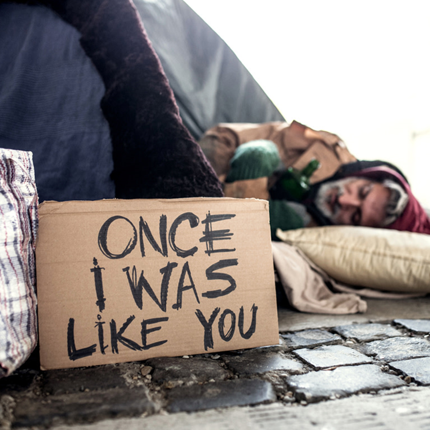 A cardboard sign that says once i was like you