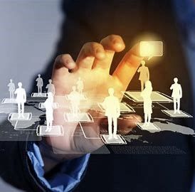 A hand reaches towards a projection of interconnected business people 