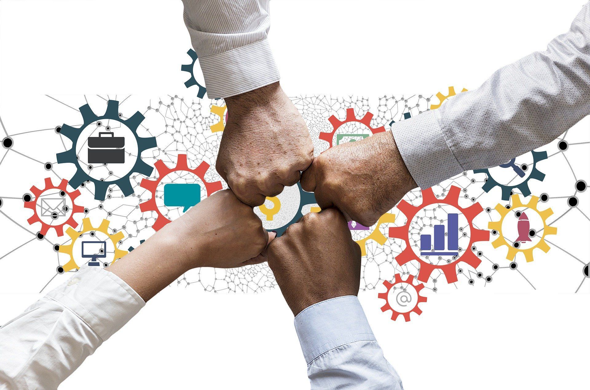 A group of business people's fists connects above a graphic depicting aspects of donor relationships