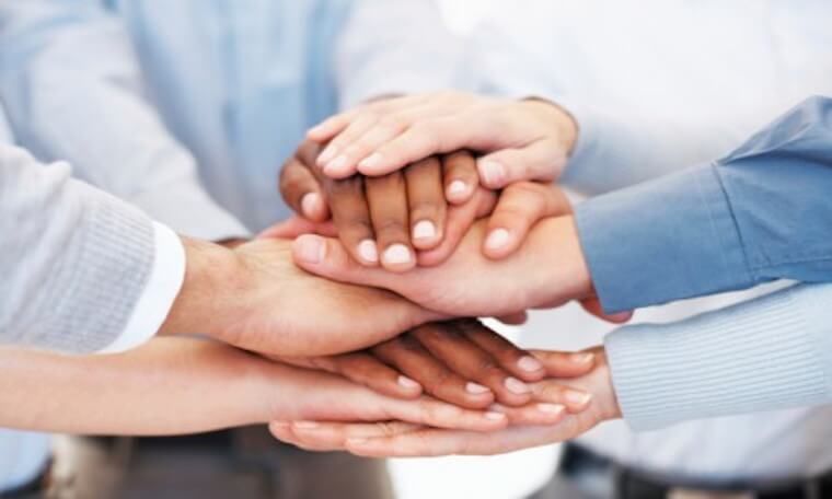 Hands piled together to boost team morale.