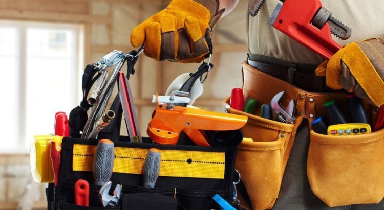 A construction worker's toolkit filled with tools