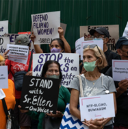 Protesters with signs, demonstrating against attacks on human rights, with signs