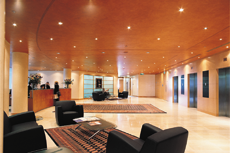 Interior View Of An Office Lobby With Lighting And Sofa Chairs