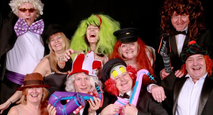 A group of people dressed in costumes are posing for a picture.