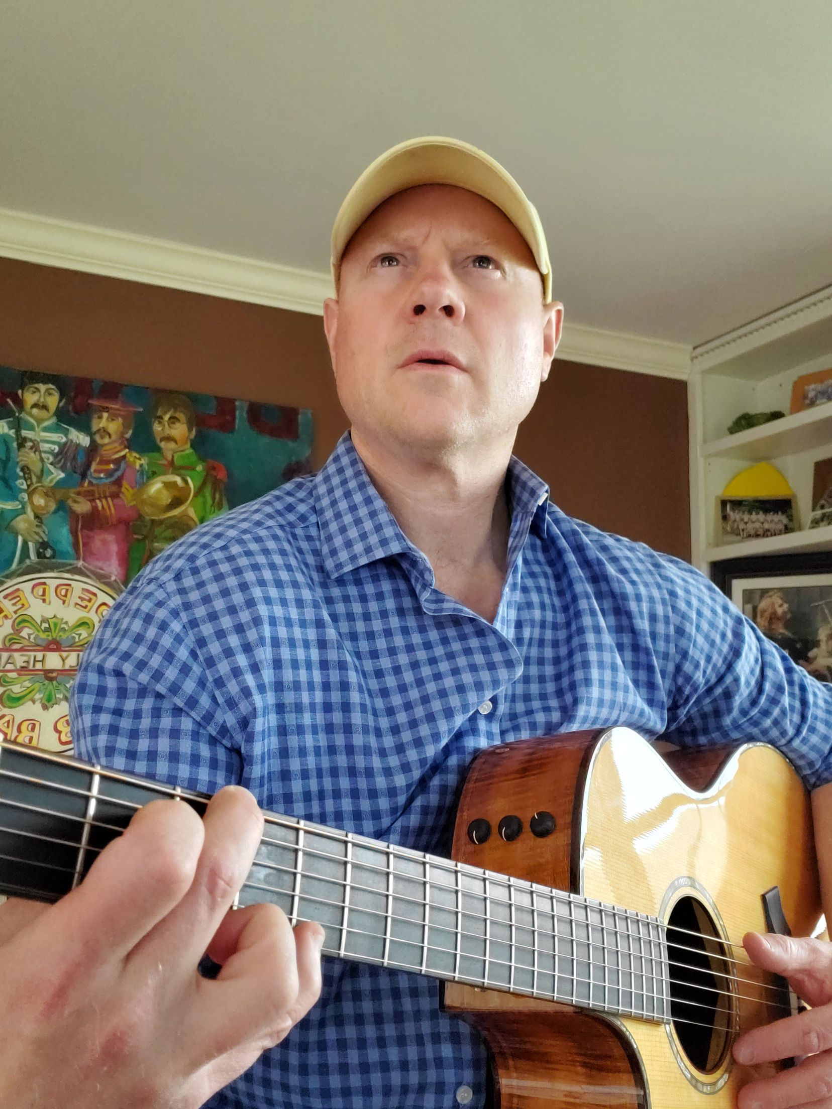Bob Cotton with his guitar, a musician who performs at isham family farm.