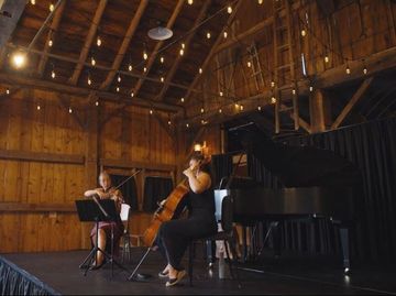 Classical concert performance inside the barn at Isham Family Farm event venue.