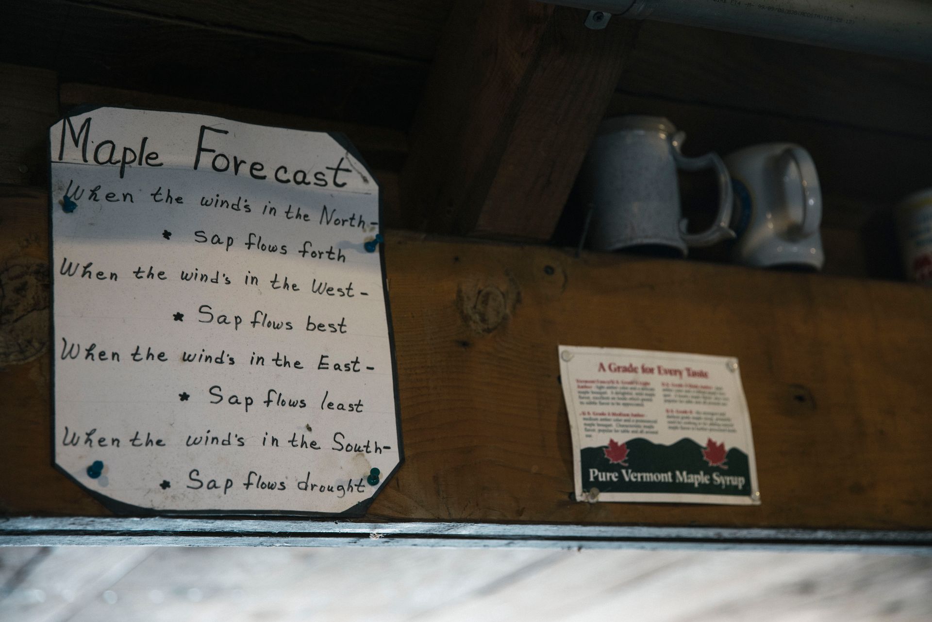 Hand written maple forecast hung above the window inside isham family farm maple shack