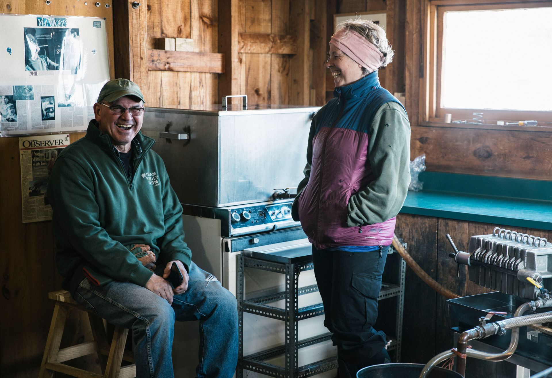 Two isham family members sharing a laugh in the isham family farm maple shack