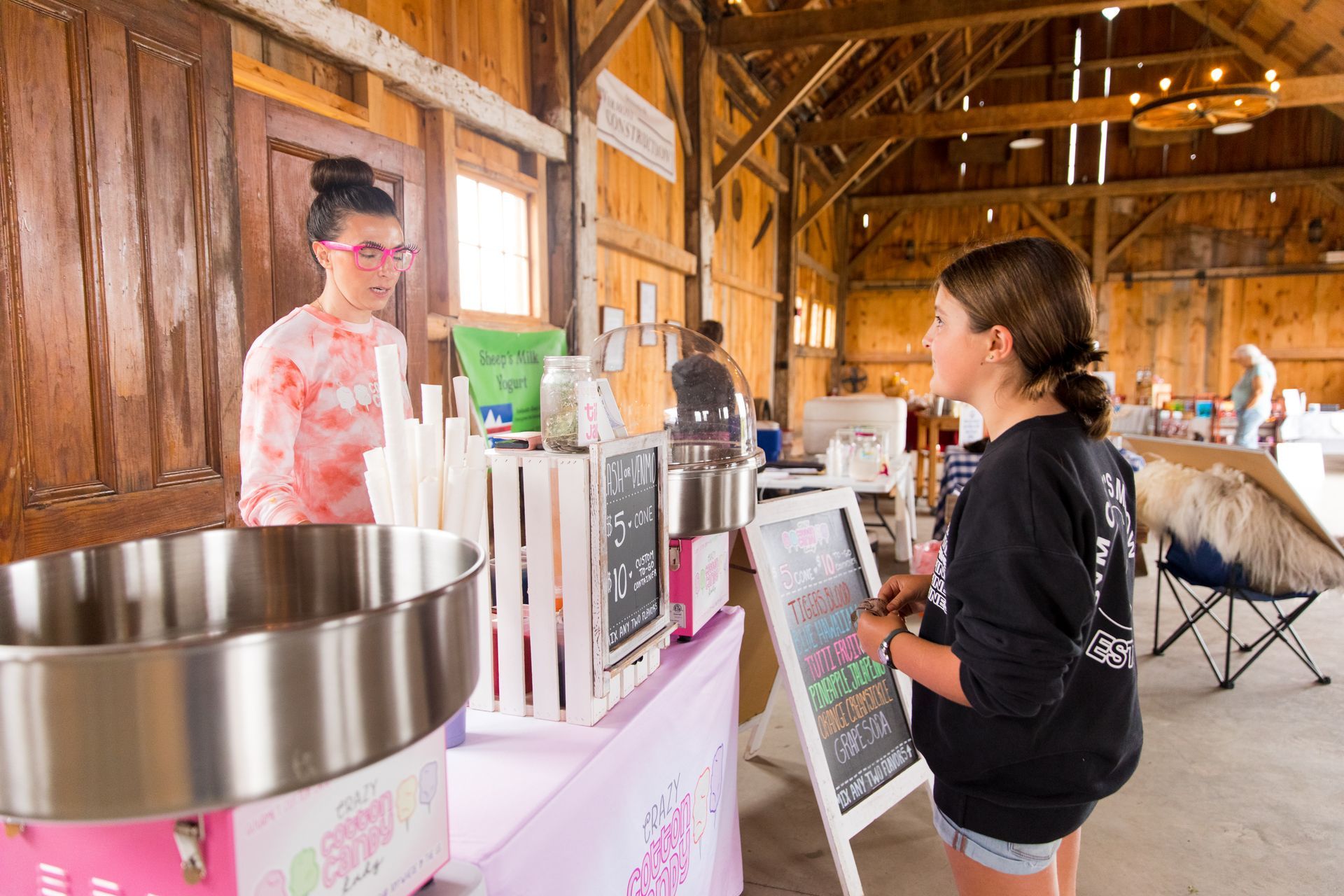 local sweets vendor talking to a young customer in the isham family farmer's market