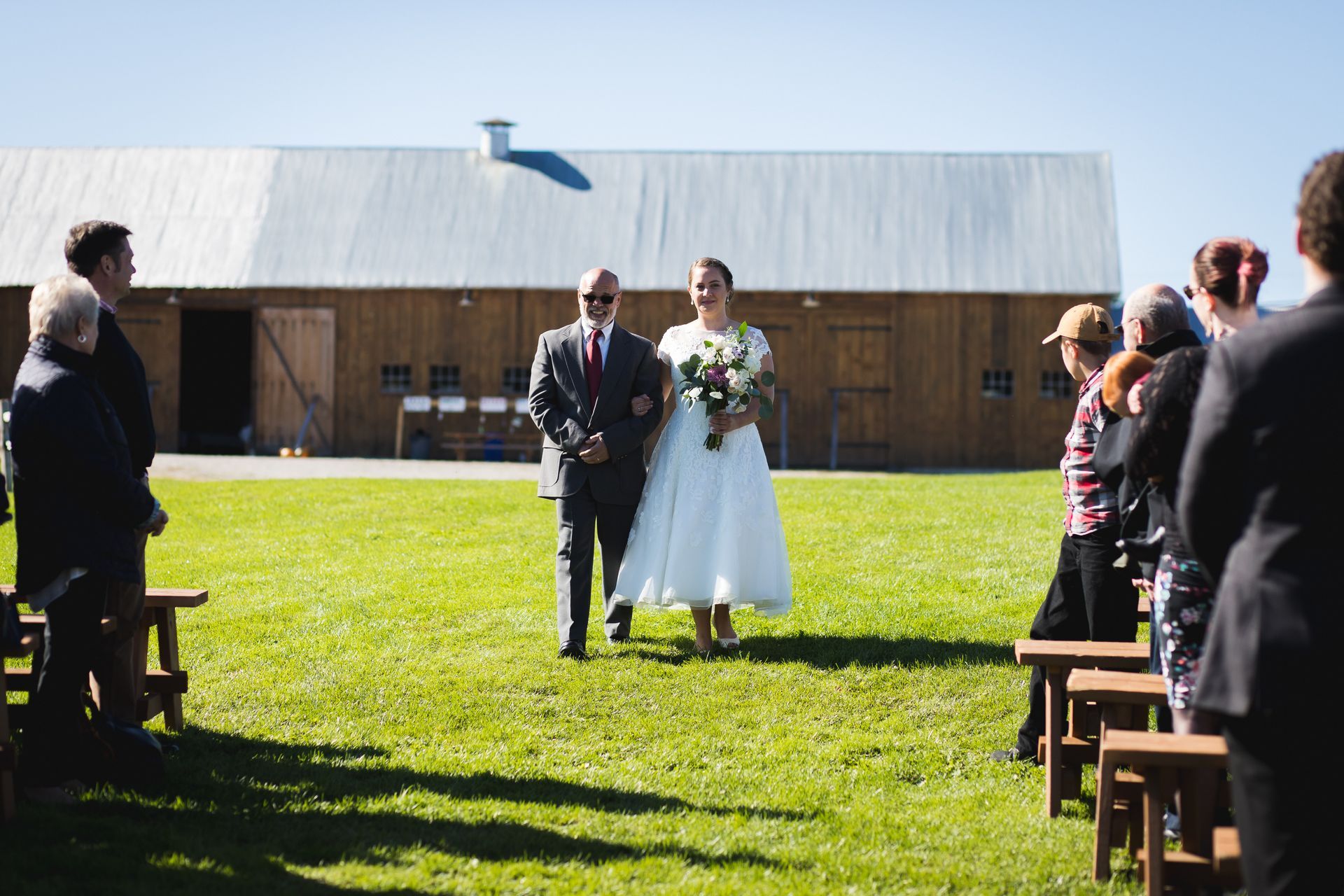 father walking his daughter down the aisle for her wedding ceremony at isham family farm