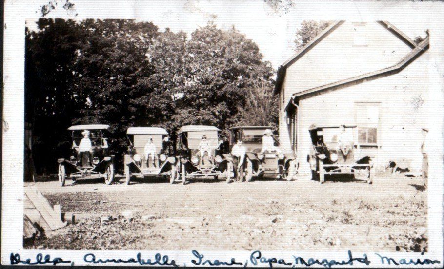 Isham Family Farm in Vermont showing family members with early 1900s automobiles in front of the original barn.