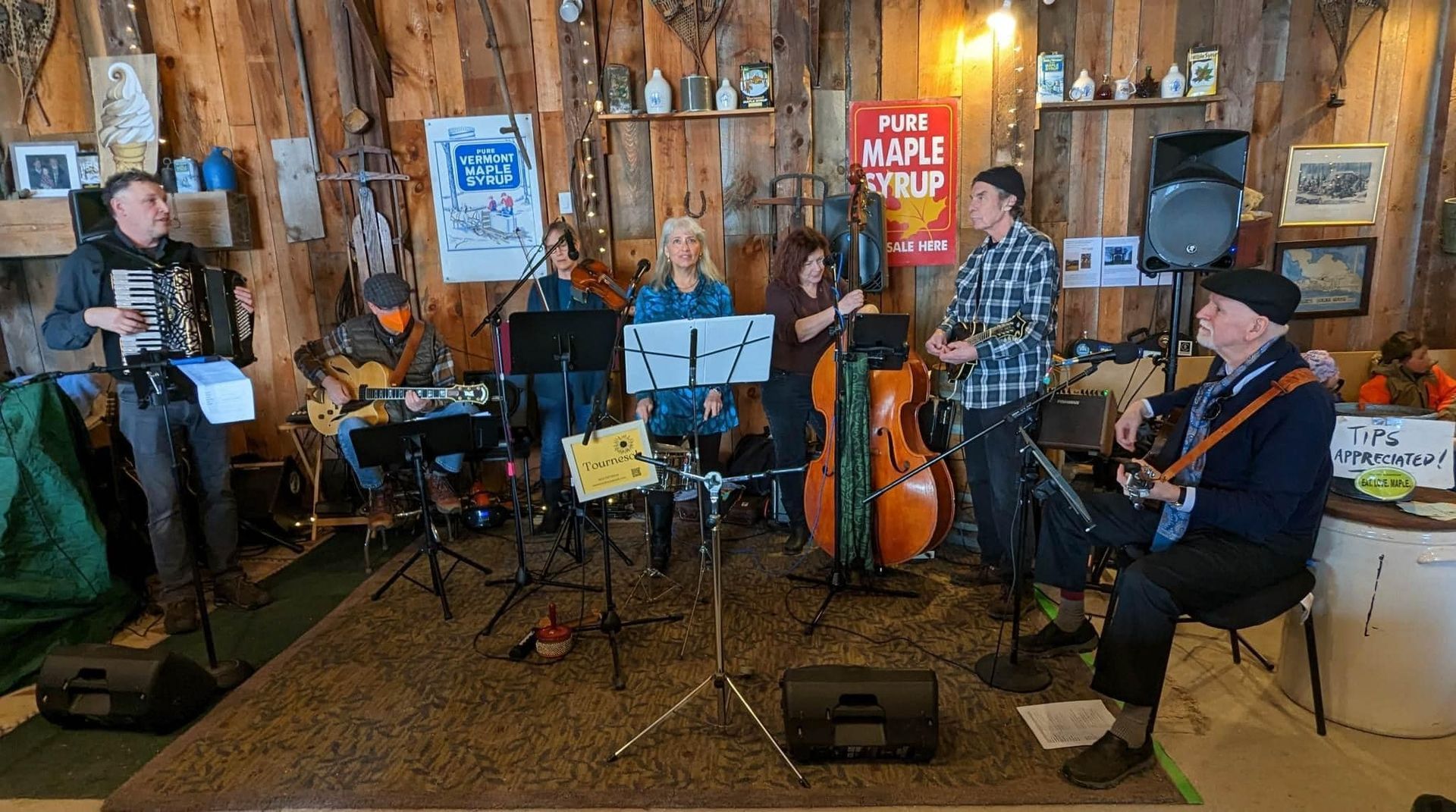 folk band performing in the events barn at isham family farm