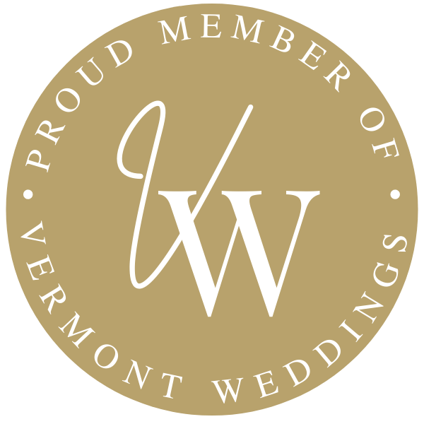Circular gold badge with white text reading “Proud Member of Vermont Weddings” and a stylized “VW” logo in the center.