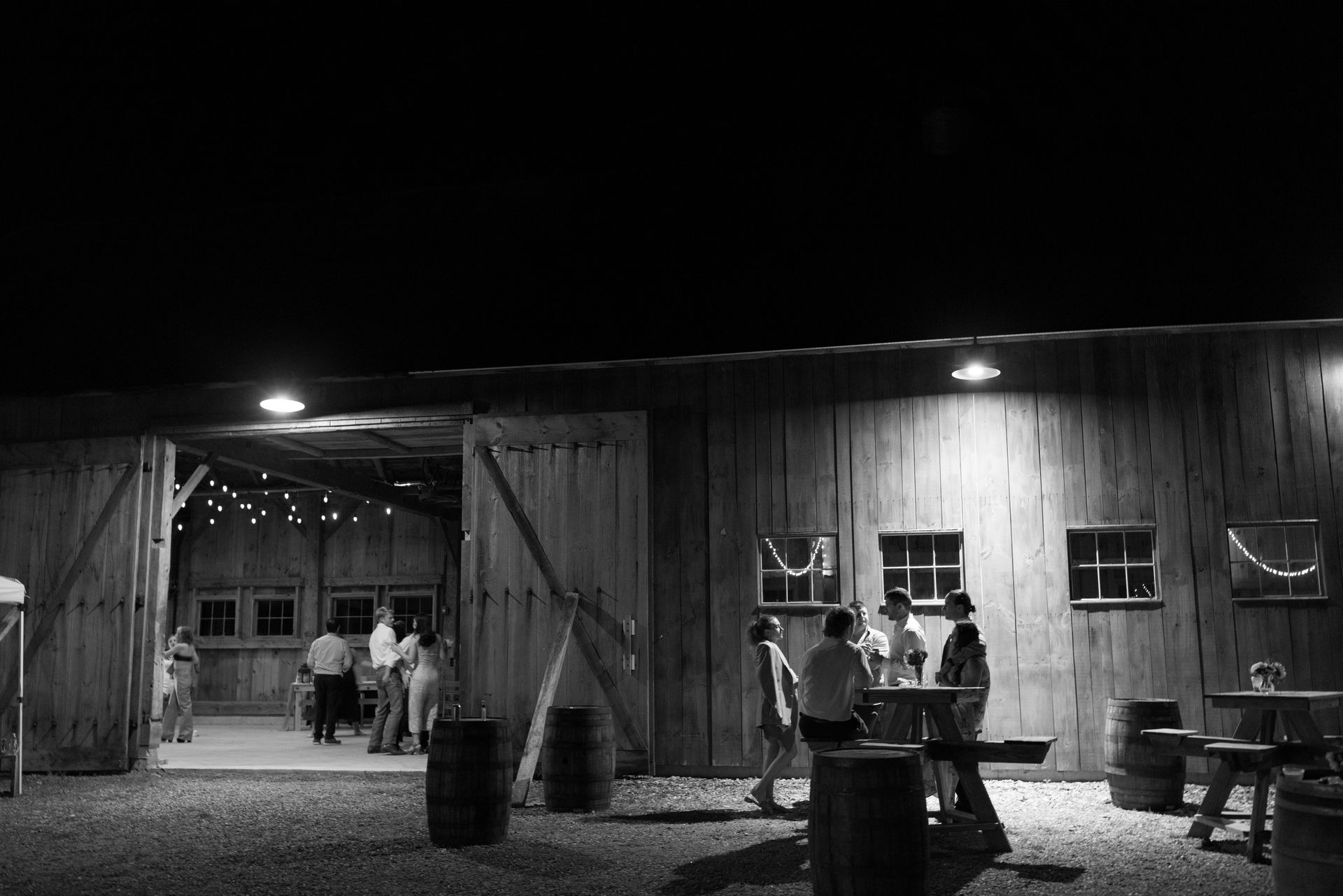 black and white photo of the isham family farm events barn during an evening wedding reception.