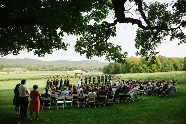 landscape shot of a wedding ceremony at isham family farm in vermont