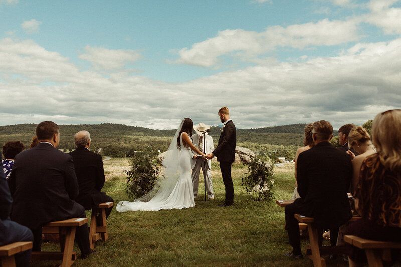 a couple getting married at isham family farm overlooking the vermont mountainside