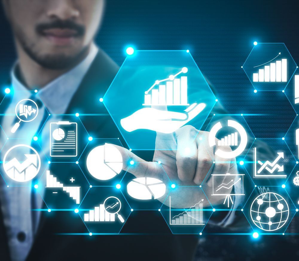 A man in a suit is touching a screen with graphs and icons on it