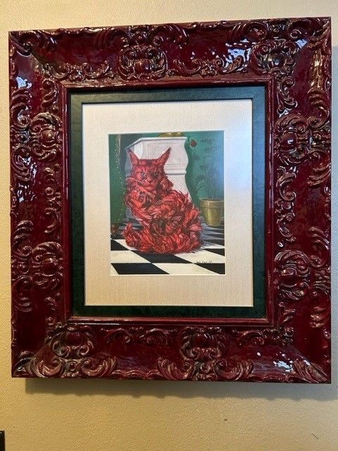 Framed artwork of a red dress on a checkered floor against a teal background. Framed artwork of a red dress on a checkered floor against a teal background.