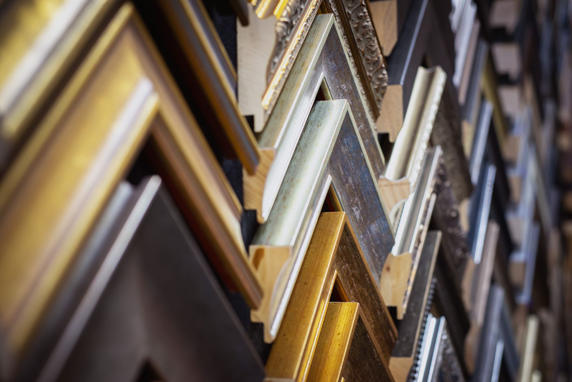 Multiple picture framing samples on a wall.