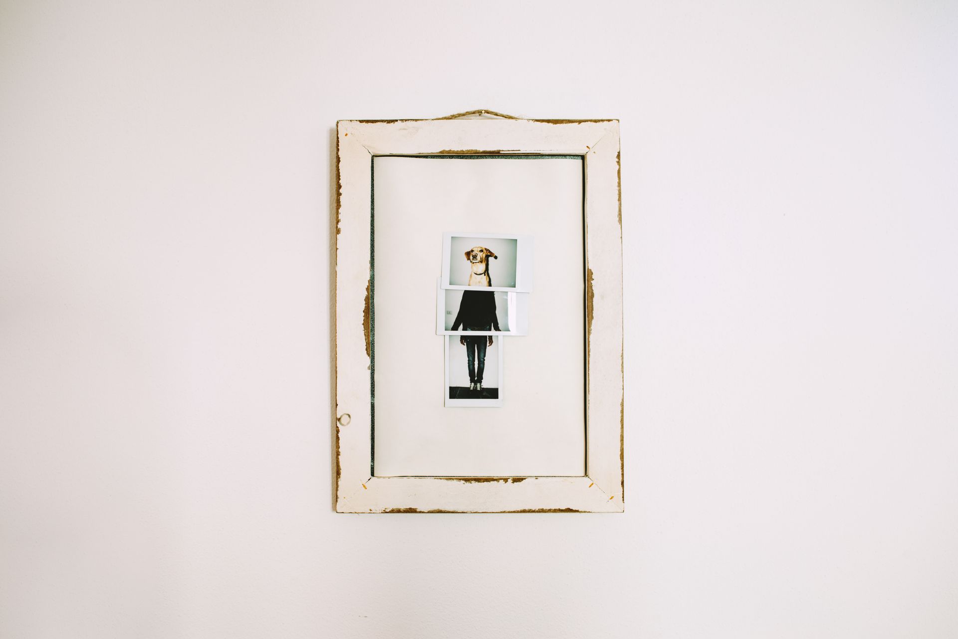Framed minimalist art with a small figure centered on a white wall Framed minimalist art with a small figure centered on a white wall