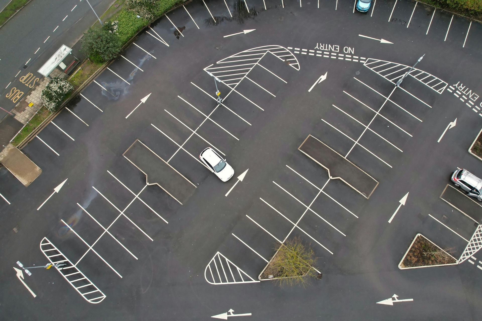 Birds-eye view of parking lot with markings for car slots