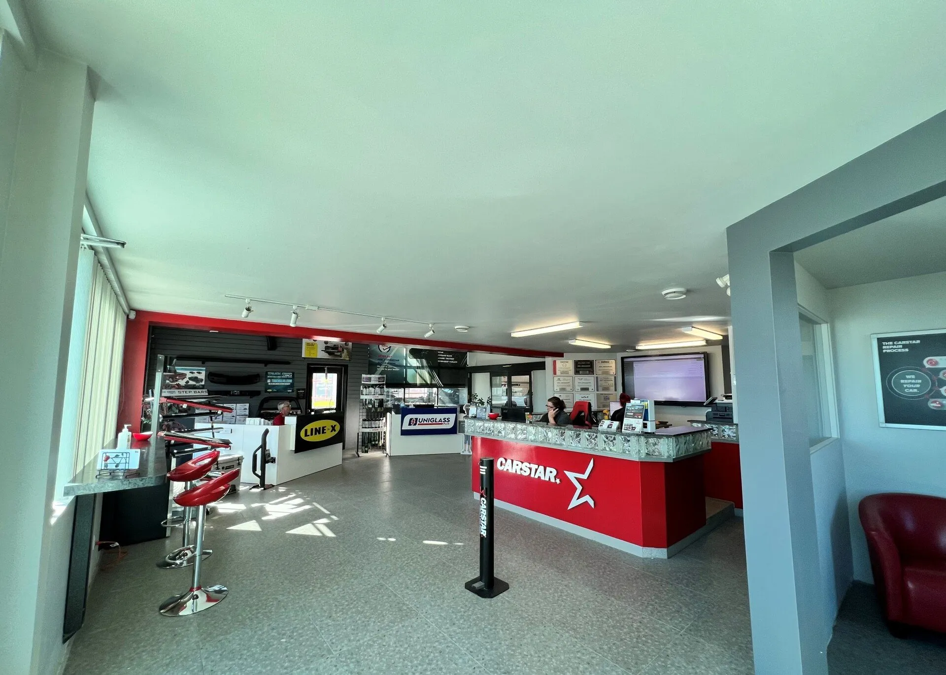 A large room with a red counter in the middle of it.