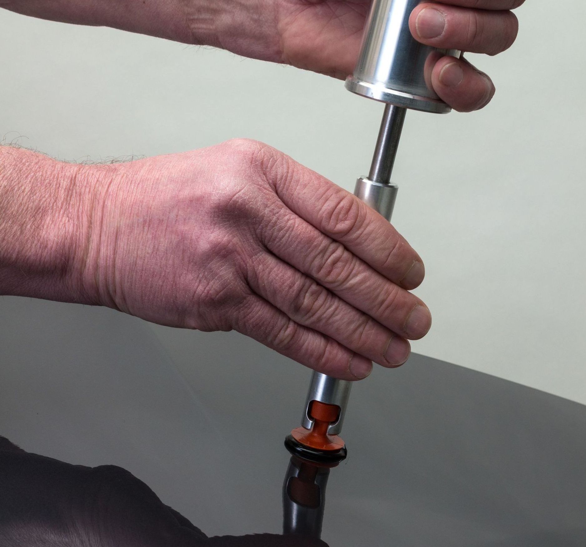 A close up of a person holding a tool in their hands