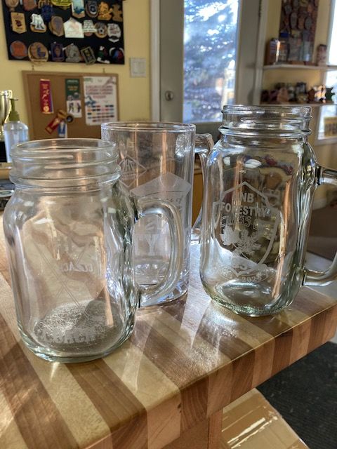 Three mason jars are sitting on a wooden table.