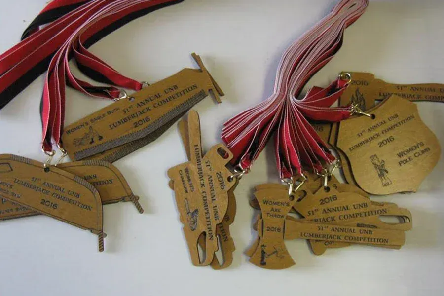 A bunch of medals are laying on a white surface