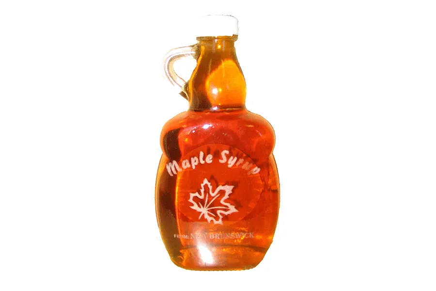 A bottle of maple syrup with a handle on a white background
