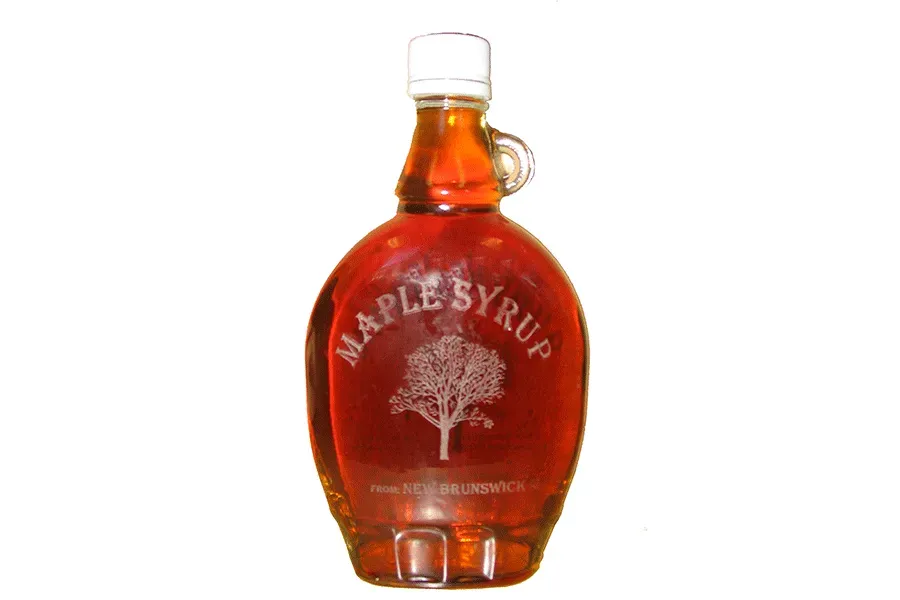 A bottle of maple syrup on a white background