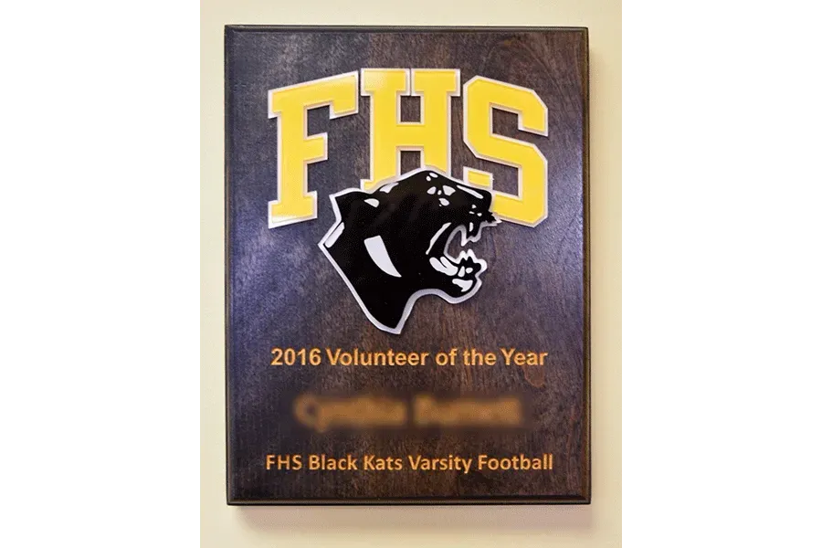 A plaque that says fhs black cats varsity football