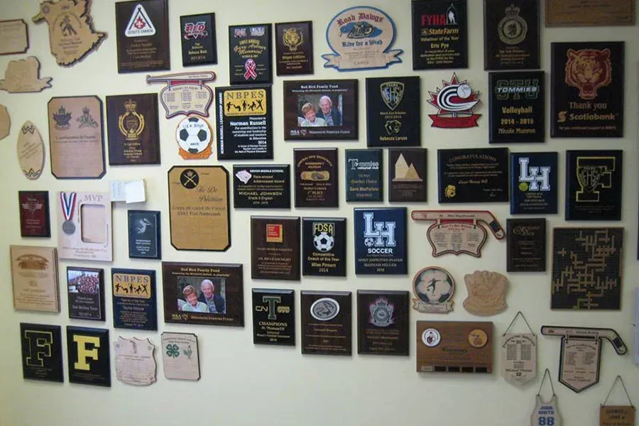A wall full of plaques including one that says lh
