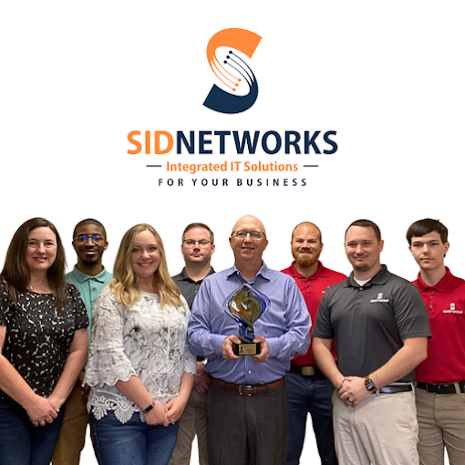 Team of IT professionals from SID Networks with logo holding a trophy.