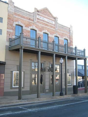 Historic Opera House building with brick facade and balcony.