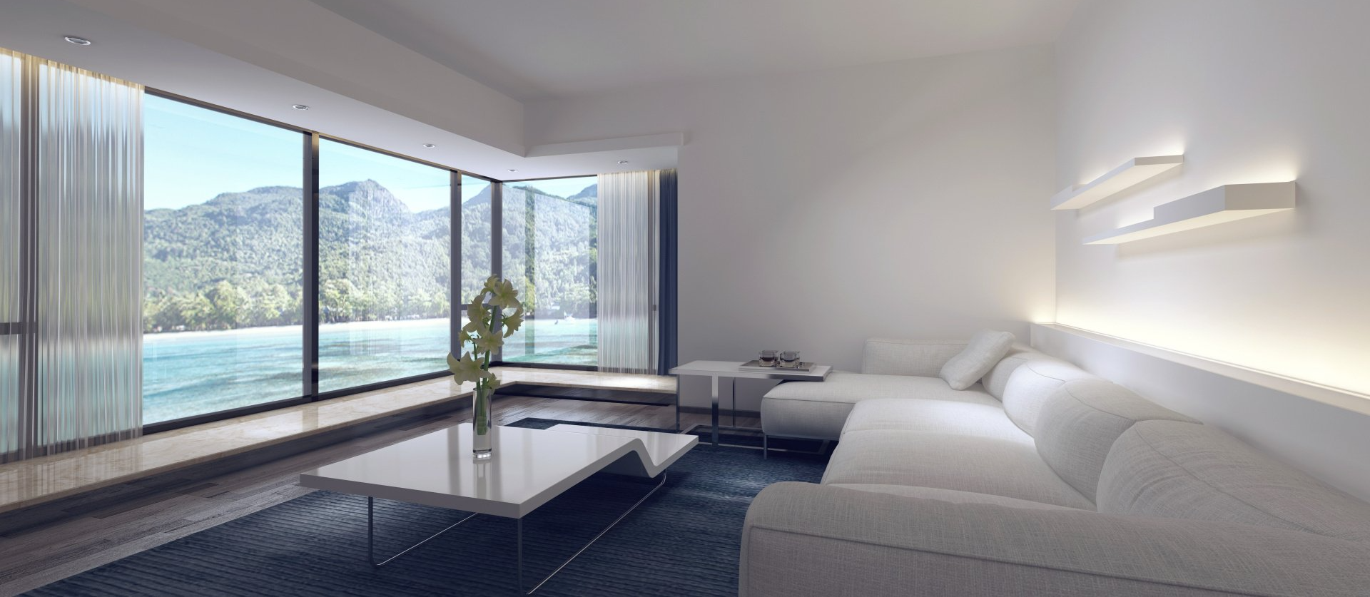 Modern white living room with a view of mountains and water.
