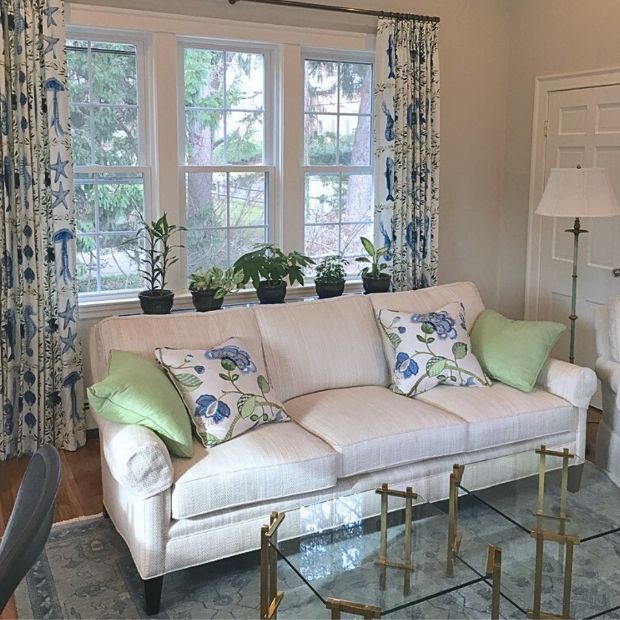 a living room with a white couch and a glass coffee table Simply Windows