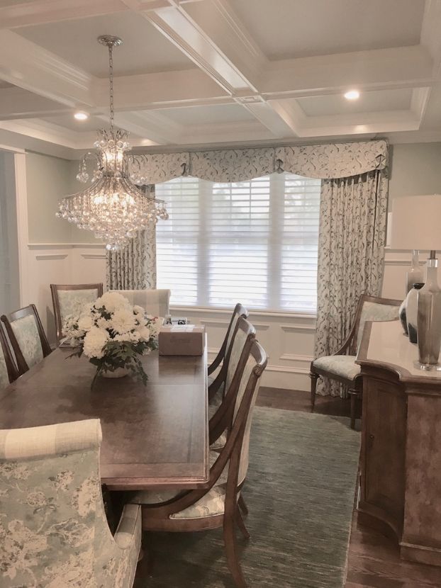 a dining room with a long table and chairs and drapery made from designer fabrics and textiles Simply Windows.