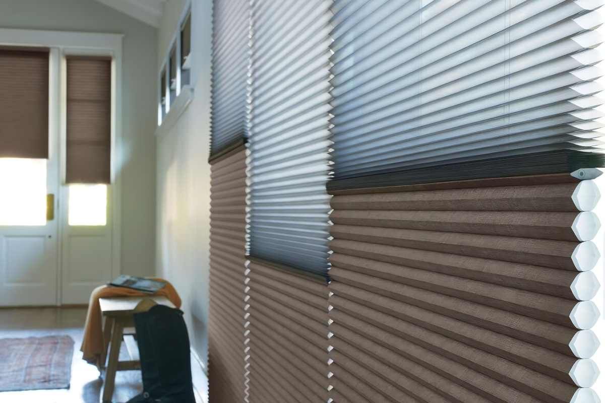 a row of honeycomb blinds on a wall in a hallway Simply Windows