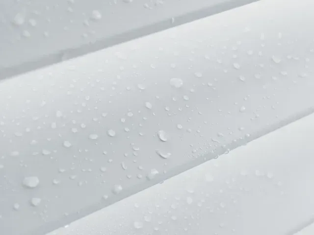 White horizontal siding with water droplets.